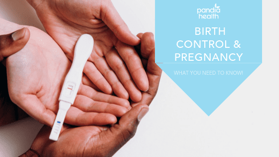 Two pairs of hands holding pregnancy test