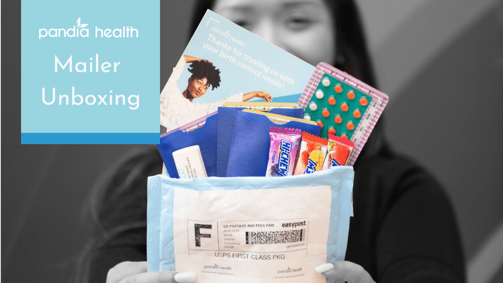 Girl holding Pandia Health mailer, unboxing her birth control and other goodies that come with the package